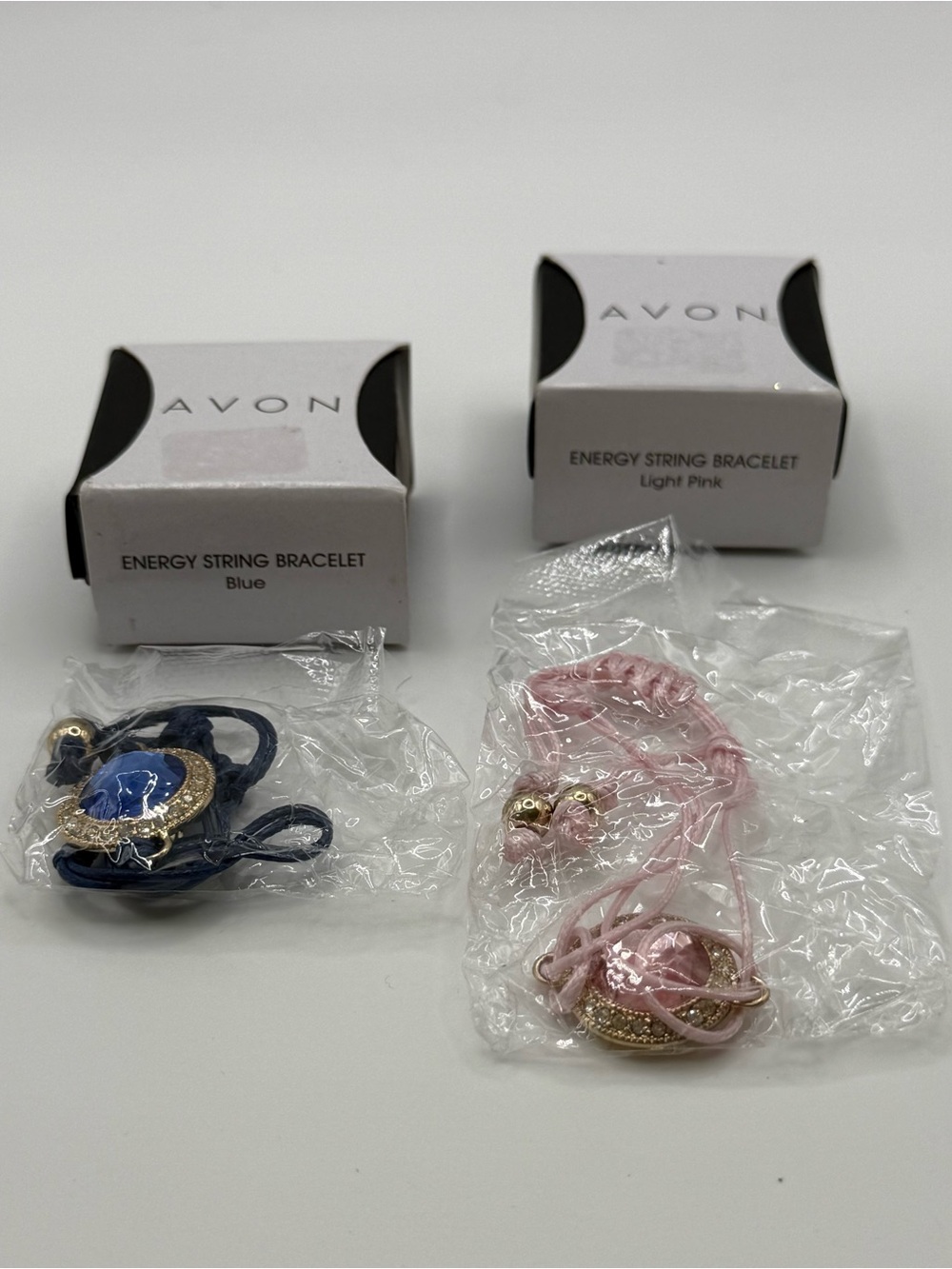 set of two Avon Energy String Bracelet - Blue and Light Pink